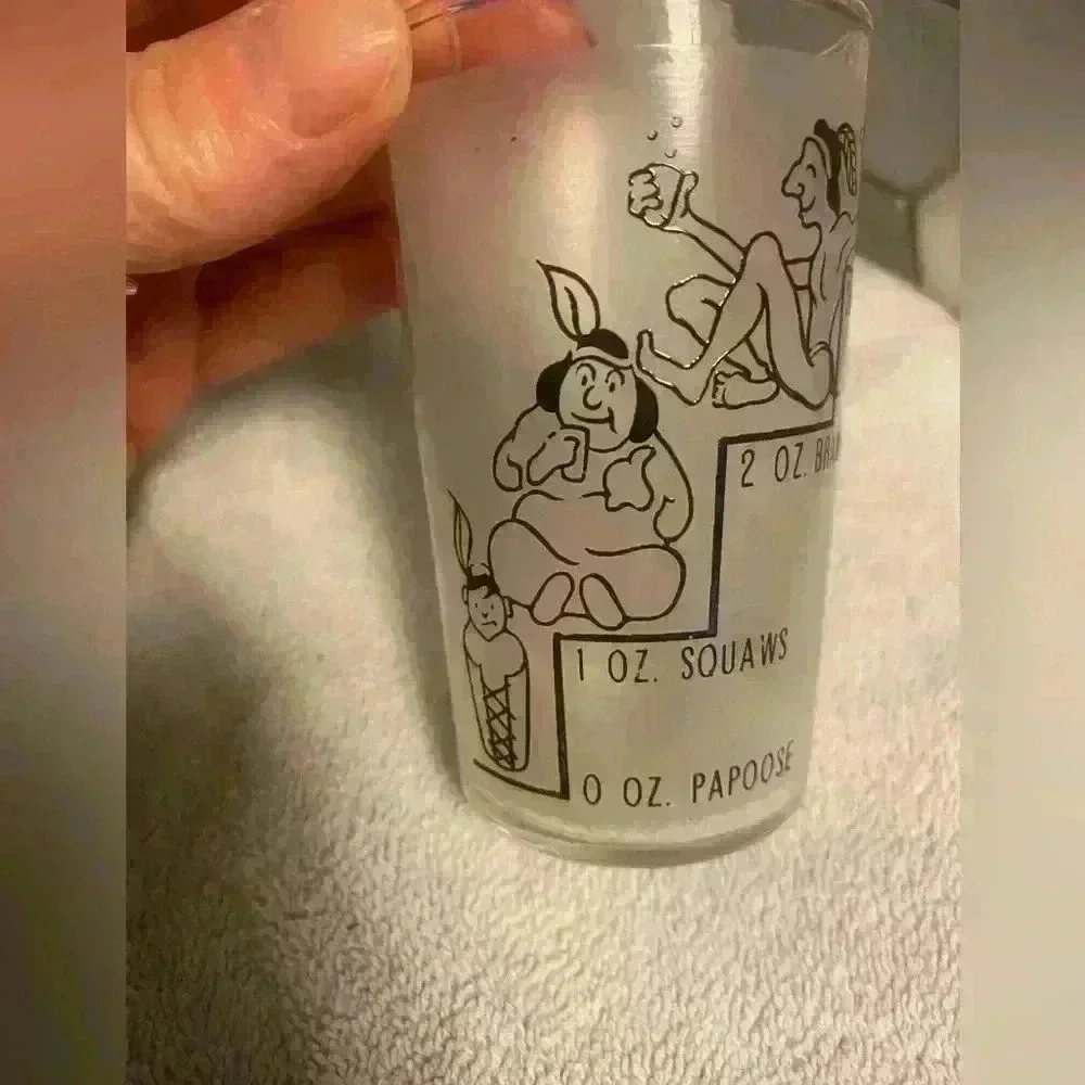 4 oz Indian novelty shot glass from Canada. Frosted glass with gold rim EUC